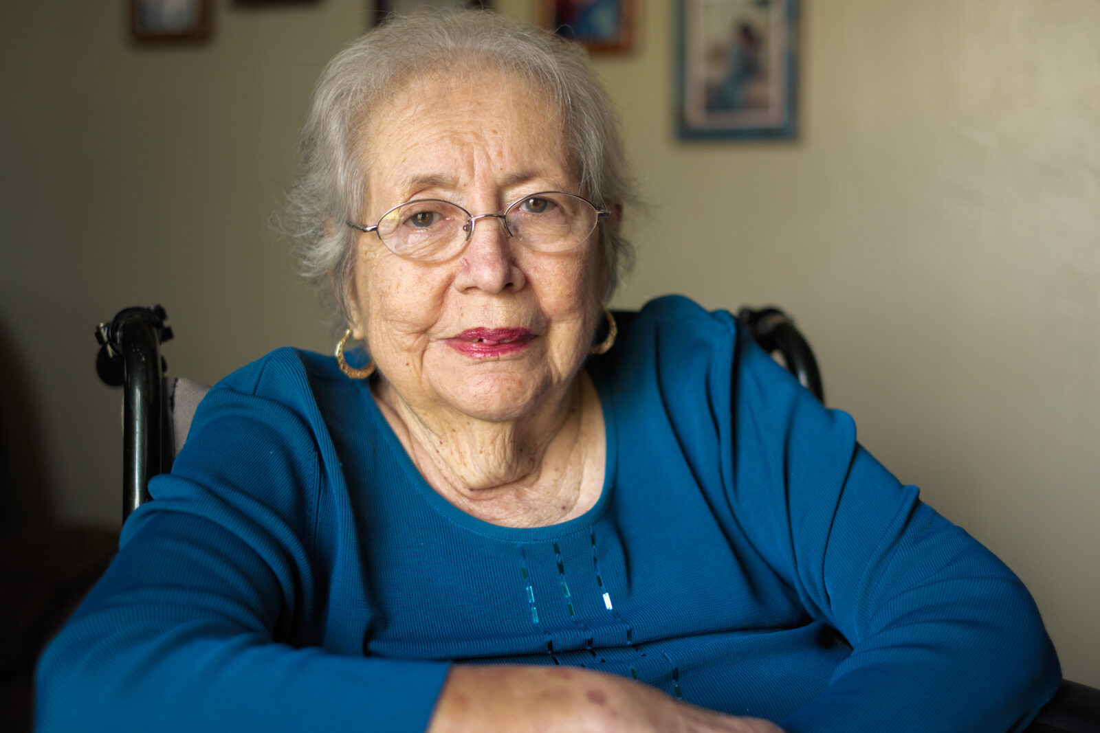senior woman wearing a blue shirt looking at the camera